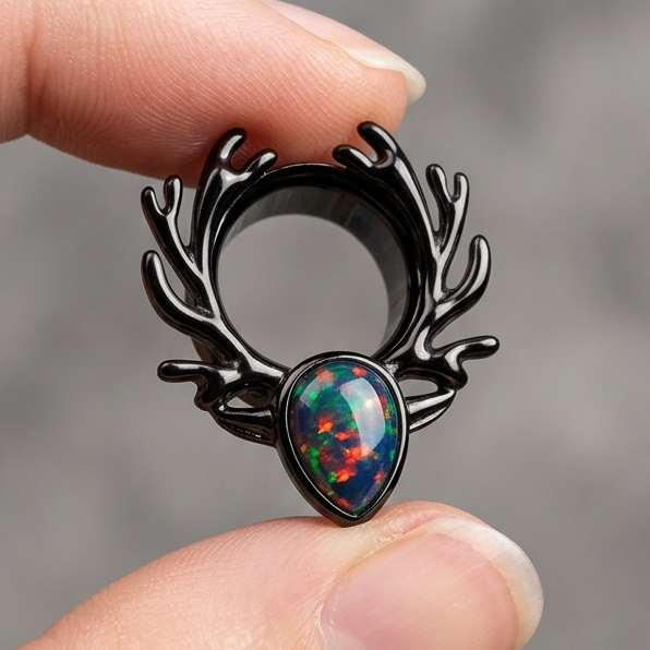 Single Black stainless steel ear tunnels featuring a deer antler design and black opal inlay, shown in 10mm size