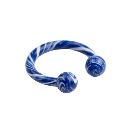 A blue and white marbled open horseshoe piercing ring with two spherical ends, photographed on a clean white background.