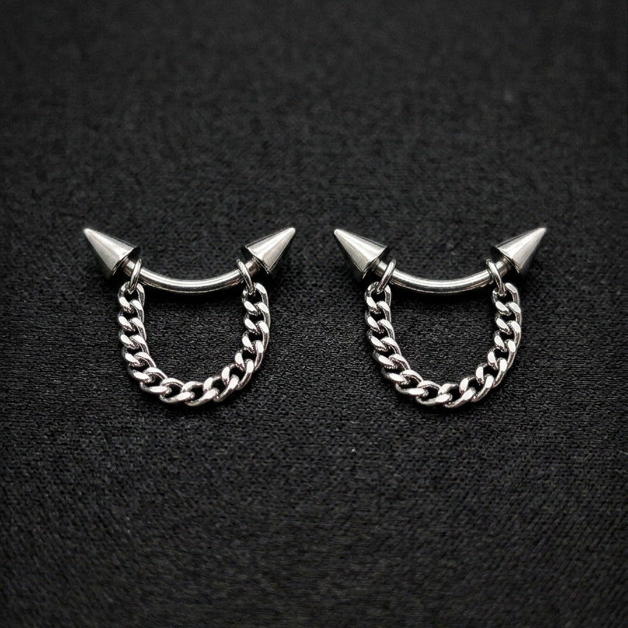 Pair of silver chain earrings with spike designs on a black background